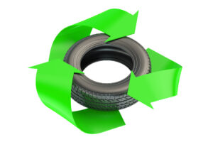 A tire inside of a recycling logo.